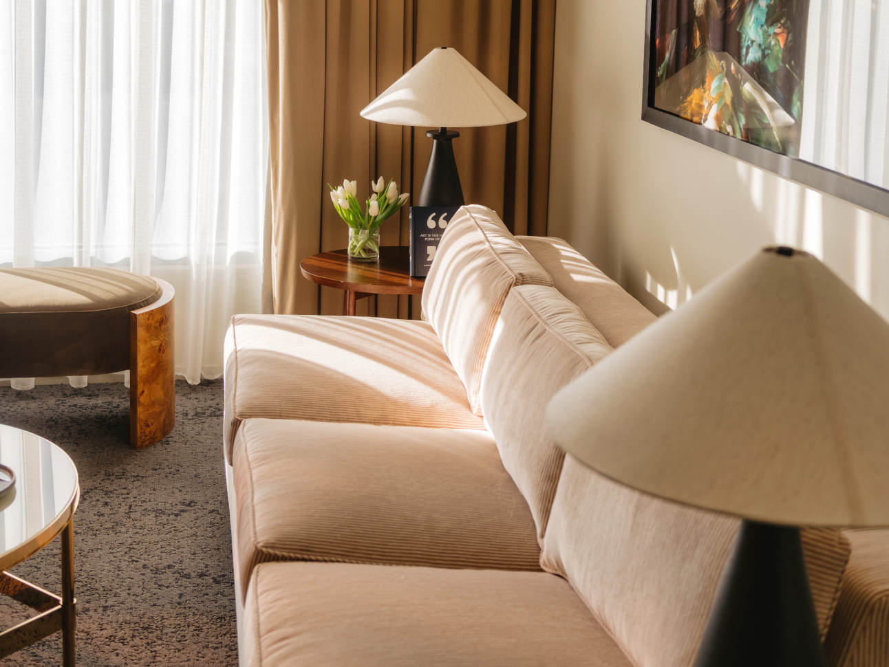 Couch, sitting area, and round table with chairs in Luxury Suite renovated at 21c Bentonville