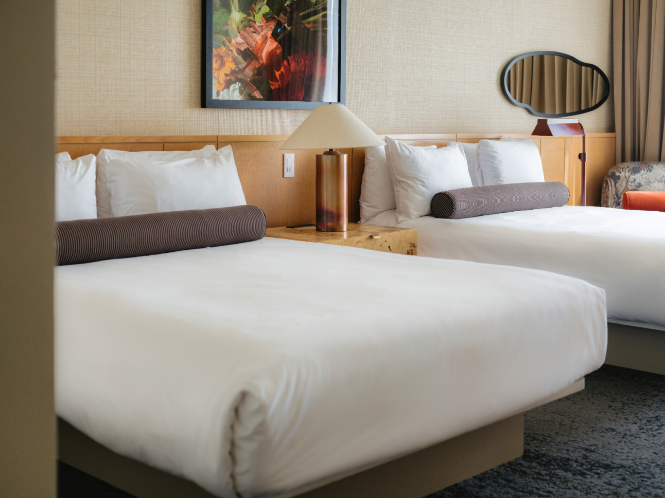 Beds and a bedside table in a Deluxe Double Queen renovated at 21c Bentonville