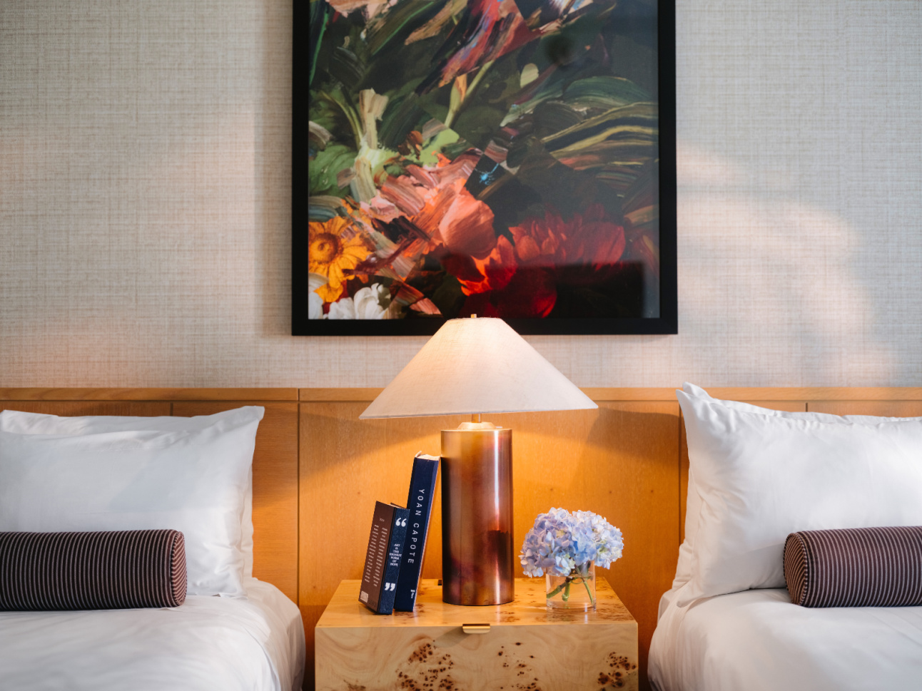 Bedside table with lamp and books in a Luxury Double Queen renovated at 21c Bentonville