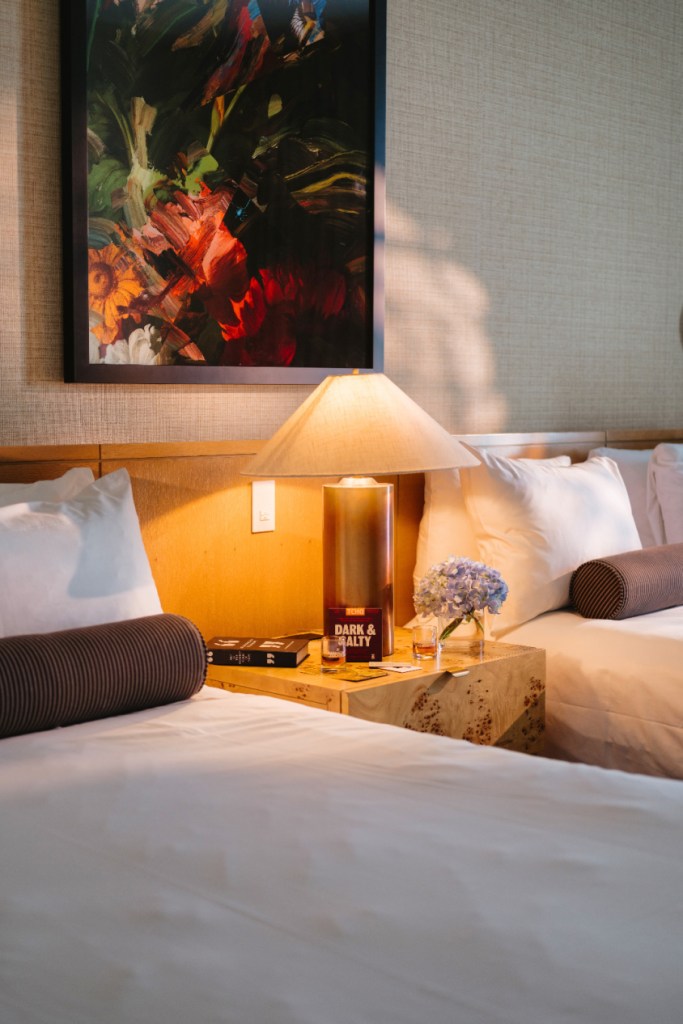 Two beds with night stand in renovated Deluxe Double Queen room at 21c Bentonville