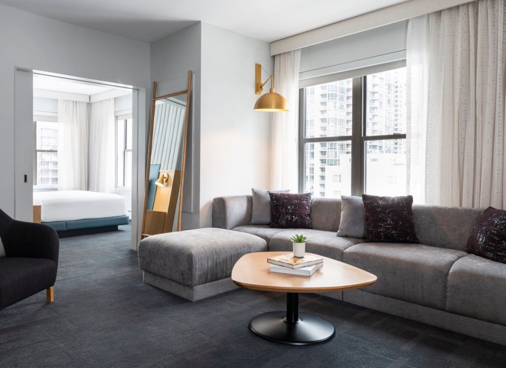 Corner Suite at a boutique hotel in Chicago featuring a spacious living area, modern decor, and city views