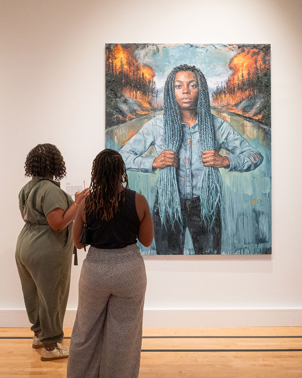 Two women looking at a painting at 21c Museum Hotel St. Louis