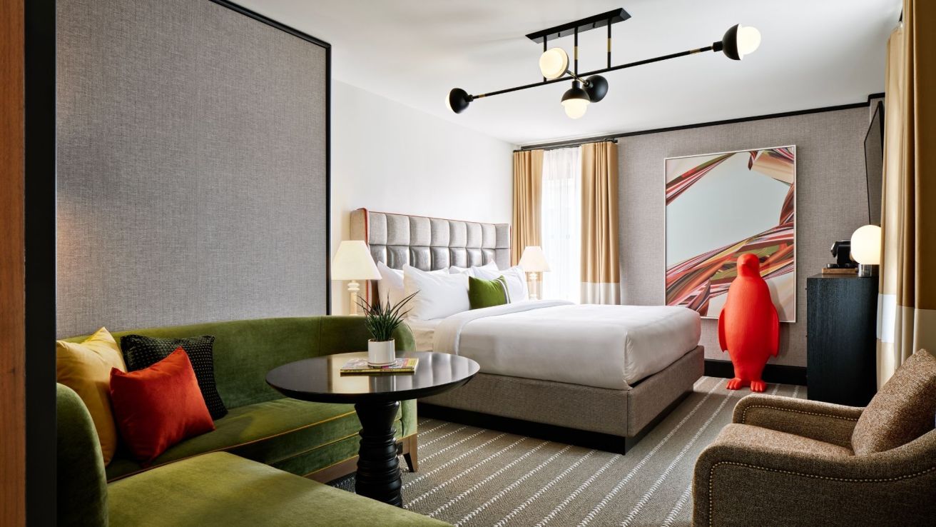 A king bed and large seating area in a hotel room