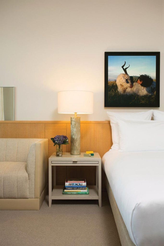 White bed with painting above it