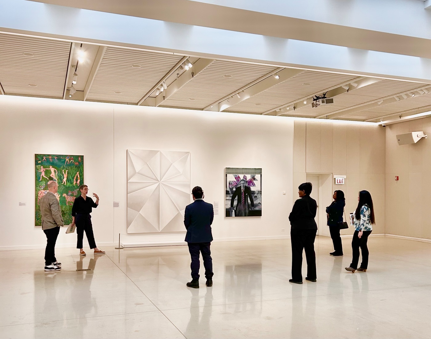 Museum curator providing a group tour to six people in Chicago.