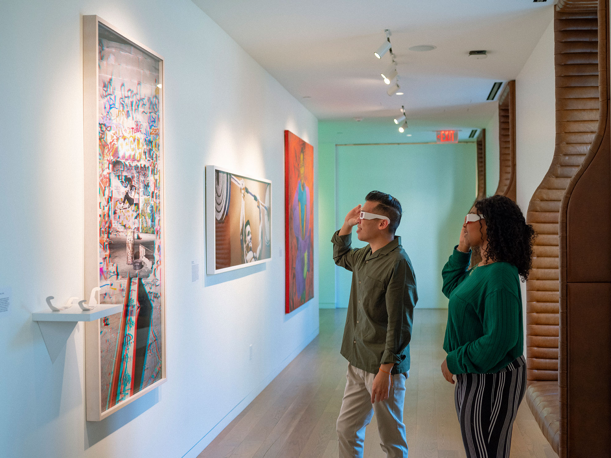 Two people using 3D glasses to look at an interactive art piece