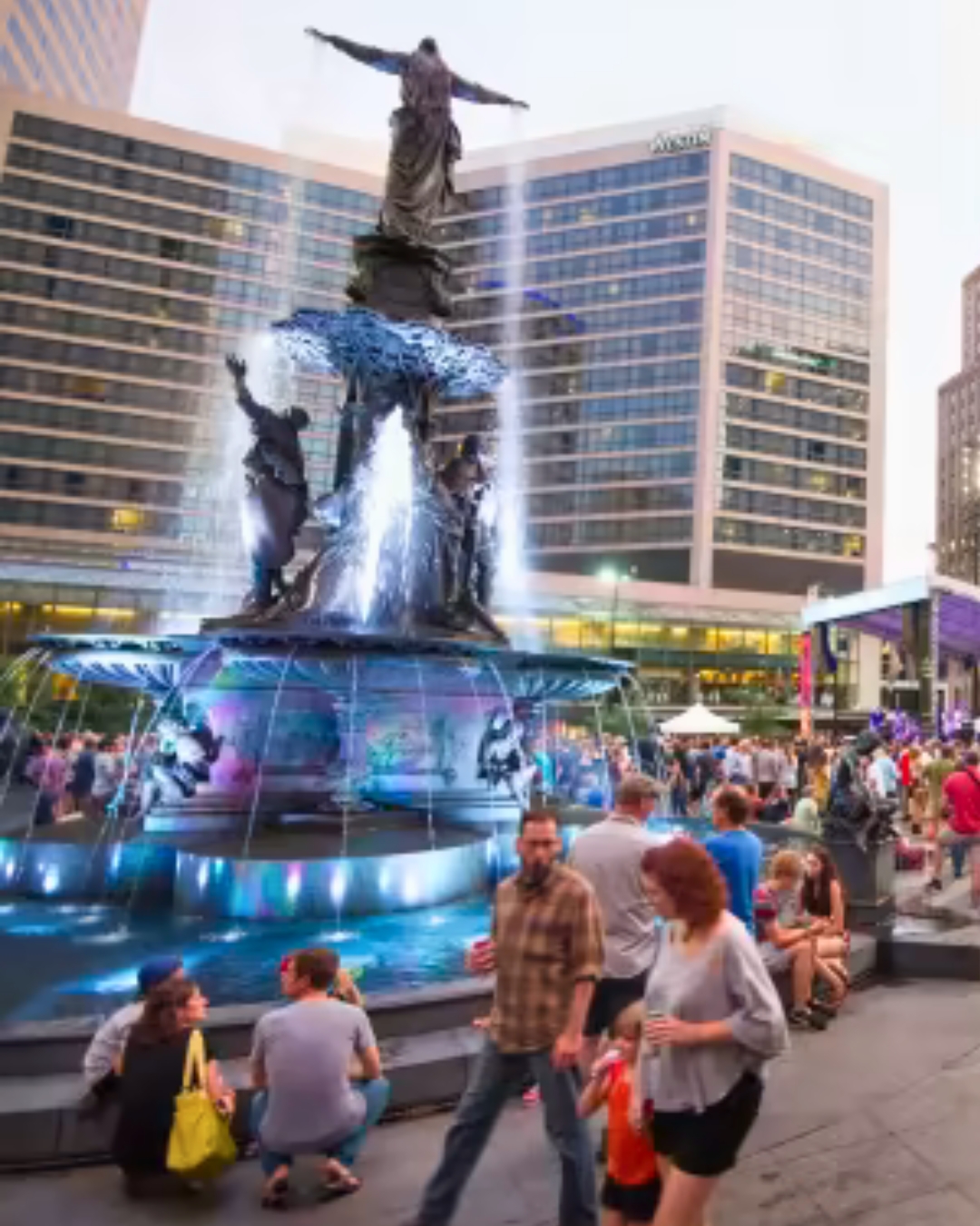 People walking around Iconic Tyler Davidson Fountain in Fountain Square.
