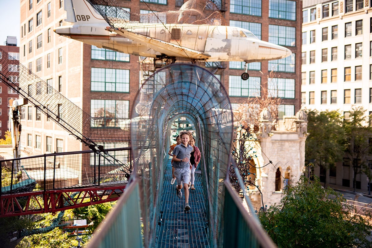 Children running across a bridge at St. Louis City Museum