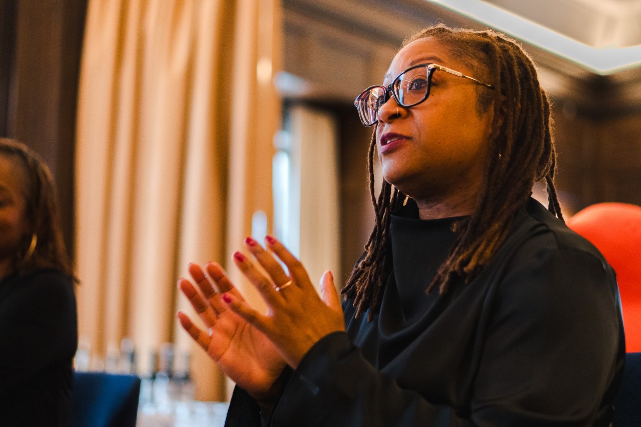 A woman in glasses speaks passionately with her hands at The Journey at 21c in St. Louis