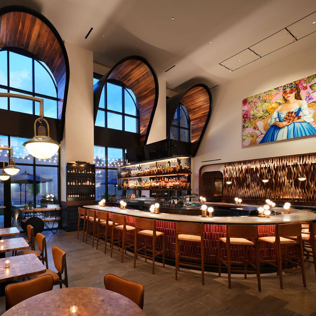 The bar at Idol Wolf with tall windows, a modern interior and art on the walls