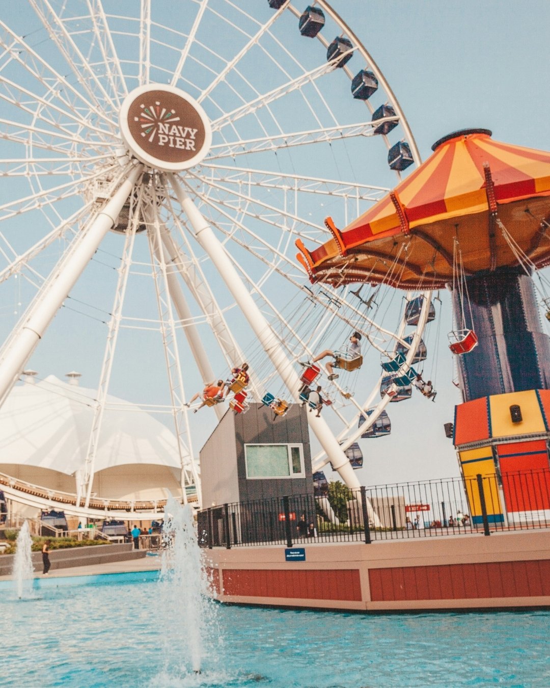 Large ferris wheel and carousel on the water