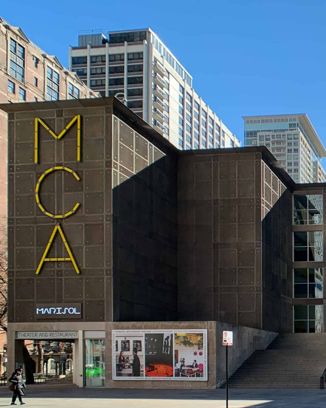 Large modern grey building with sign that says MCA on it