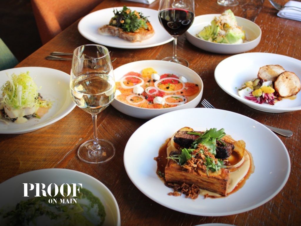 A beautiful table spread of dishes from Proof on Main.