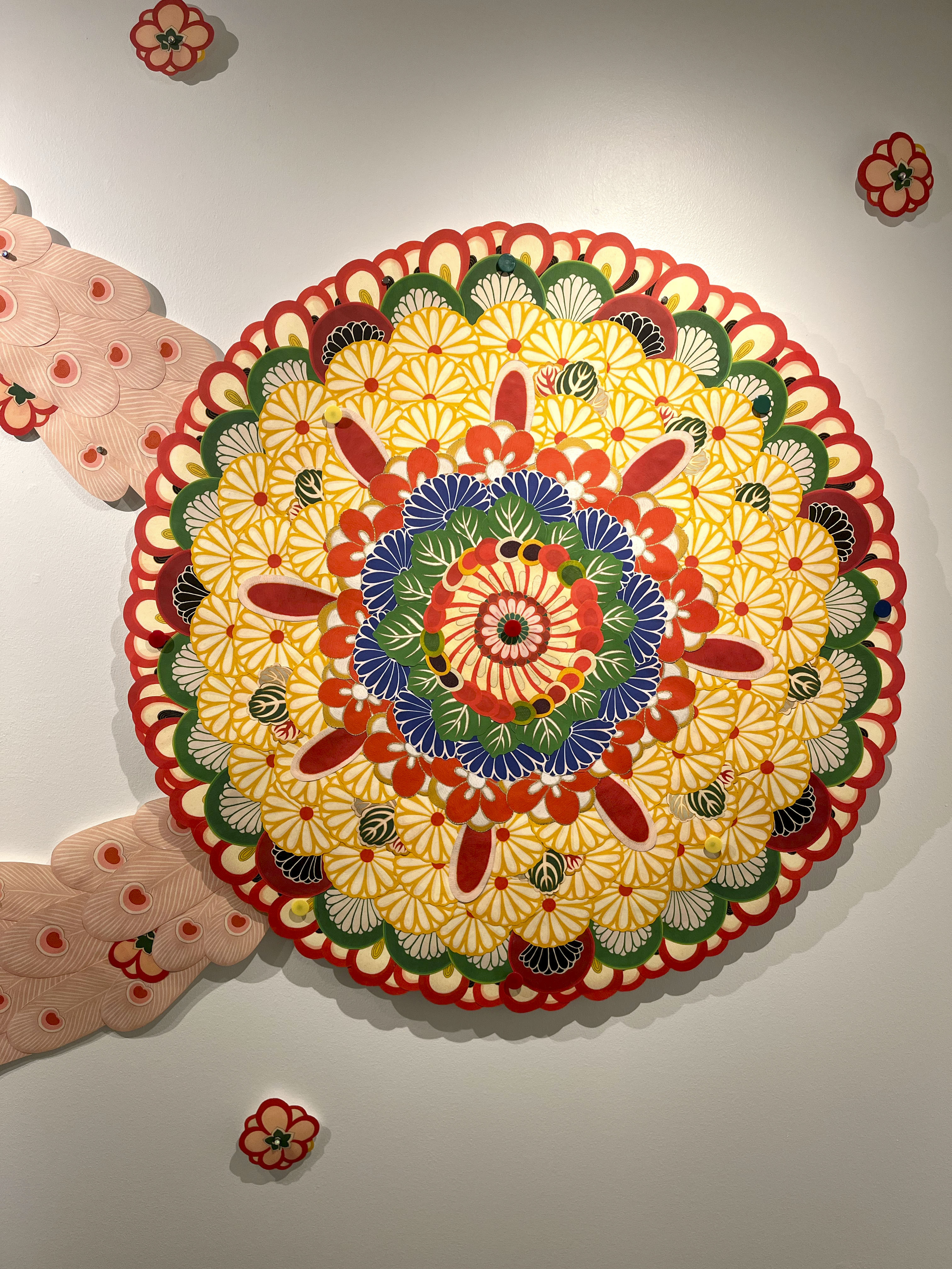 Colorful patterned circle of paper with flower motif.