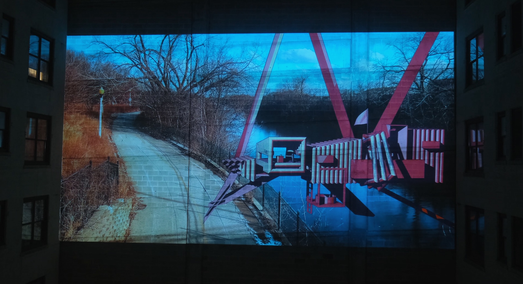 A large metal structure on a walkway near a river