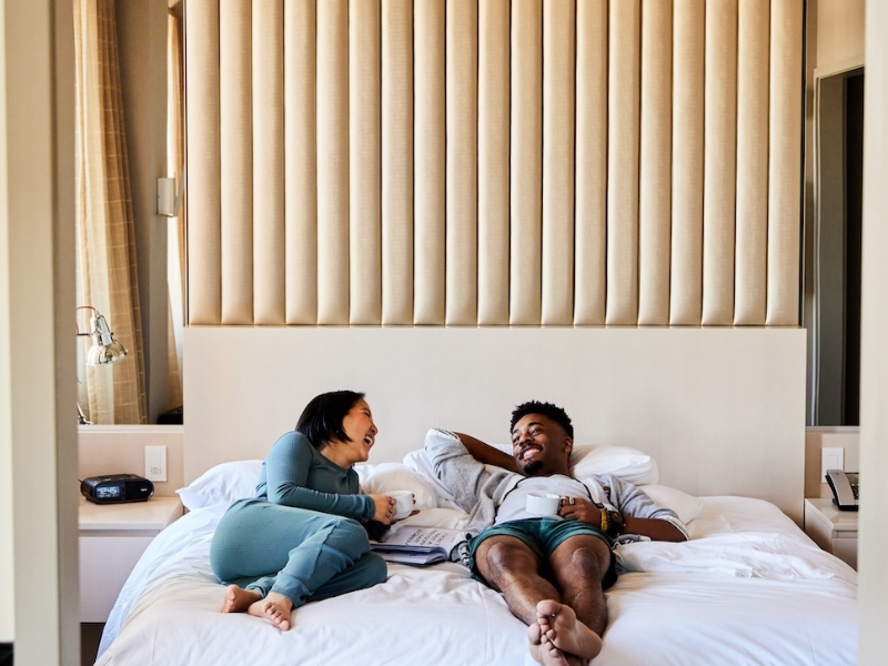 man and woman lay in bed