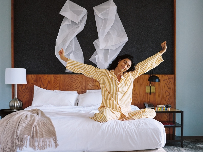woman stretching in bed