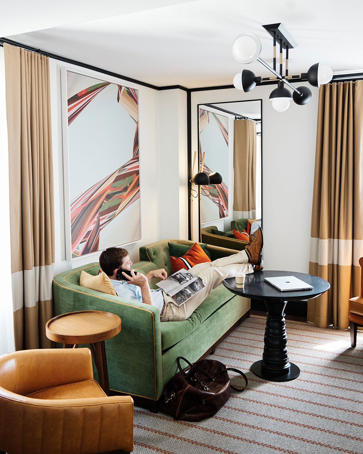 A man works remotely on his lap top in a suite at 21c Museum Hotel St. Louis