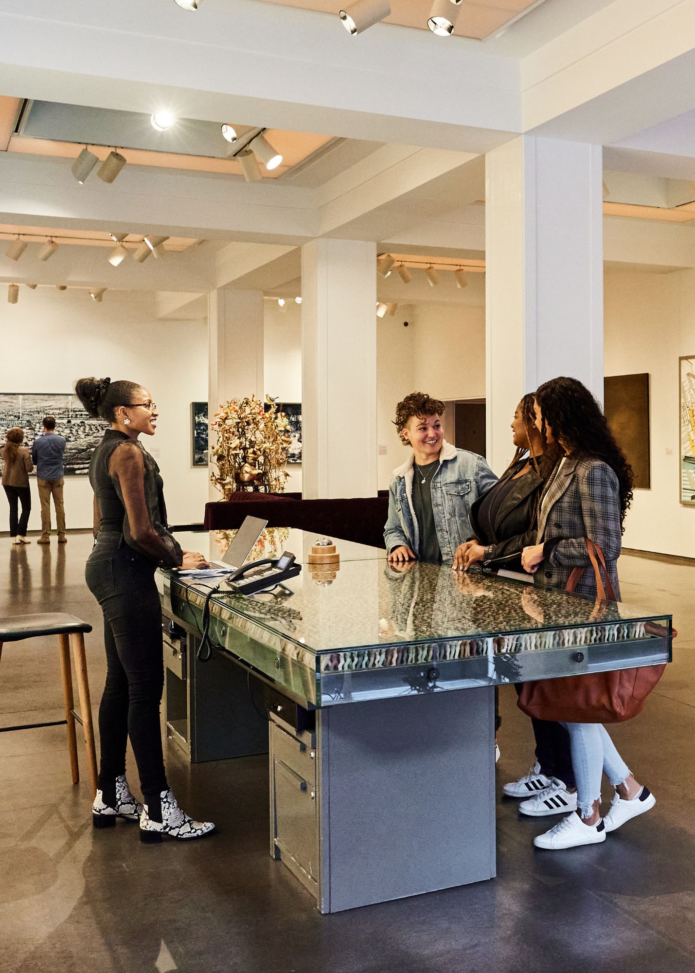 Three women at front desk checking-in to 21c Museum Hotel Cincinnati.