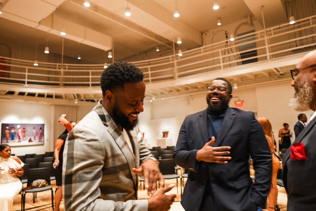 Two men laughing in the Main Gallery at 21c Museum Hotel St. Louis