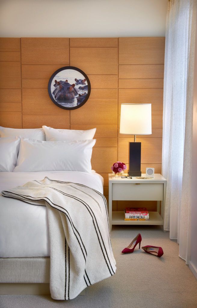 bed with a blanket and heels on the ground