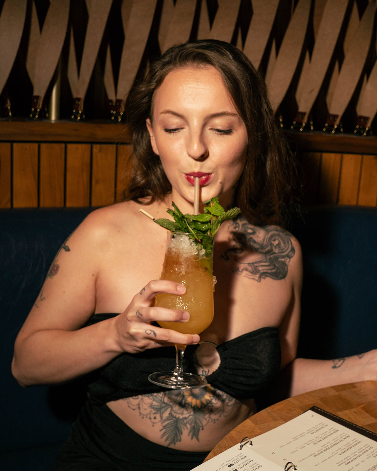 Woman drinking a Mai Tai at Idol Wolf at 21c Museum Hotel St. Louis