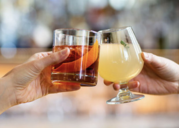 Two cocktails cheersing at Proof on Main restaurant