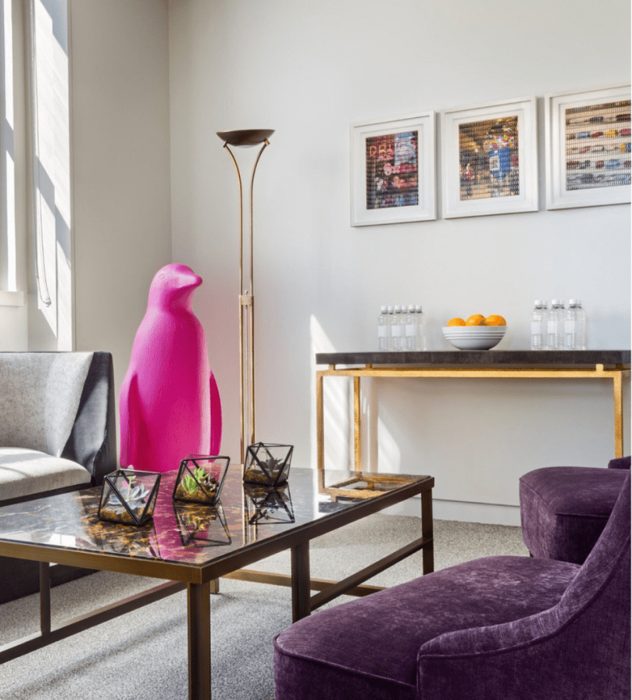 Room with purple sofa and pink pinguin